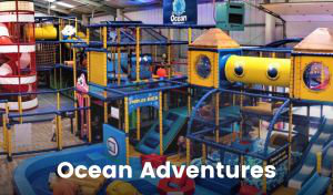 A colourful nautically-themed indoor play area made up of climbing frames, tunnels, towers, slides, ramps and fun obstacles, plus a ball pit.